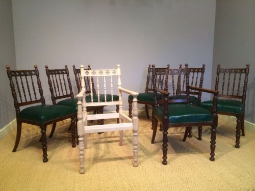 a set of eight gothic oak dining chairs