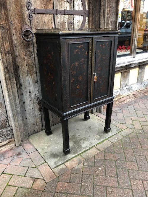 an early 19thc lacquered and decorated cabinet on stand
