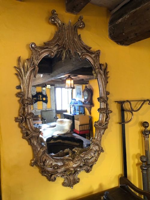 an 18thc carved and gilded oval shaped mirror
