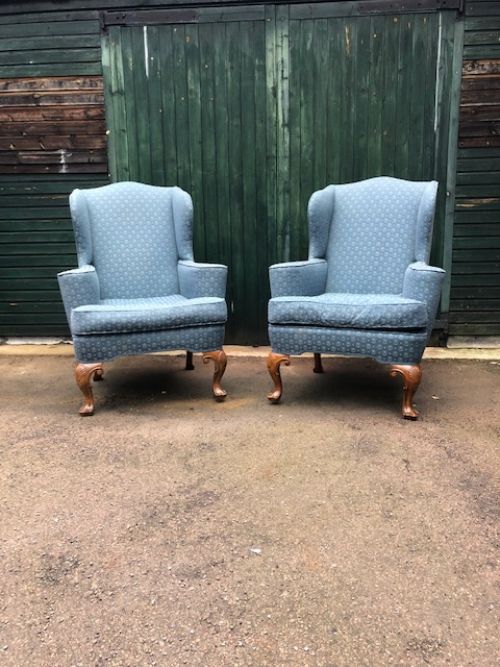 a pair of early 20th century mahogany cabriole leg wing armchairs