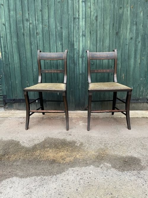 a pair of regency decorated side chairs