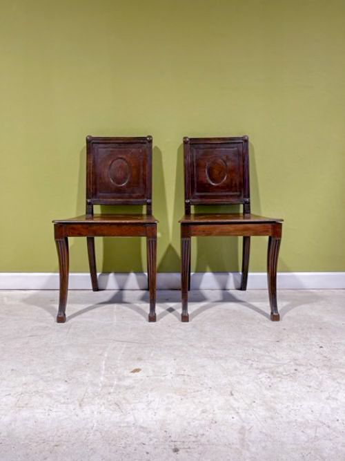 a pair of early 19th century mahogany hall chairs in the style of marsh tatham
