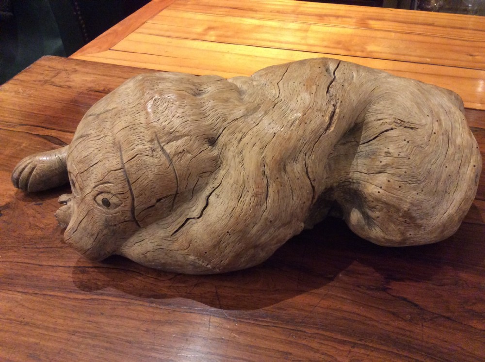 folk art wood carving of a recumbent dog c1890