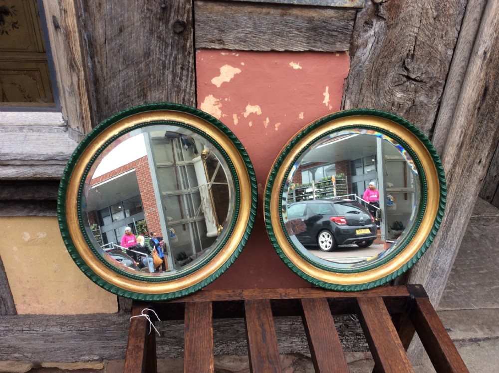 a 19thc pair of decorated circular bevelled mirrors