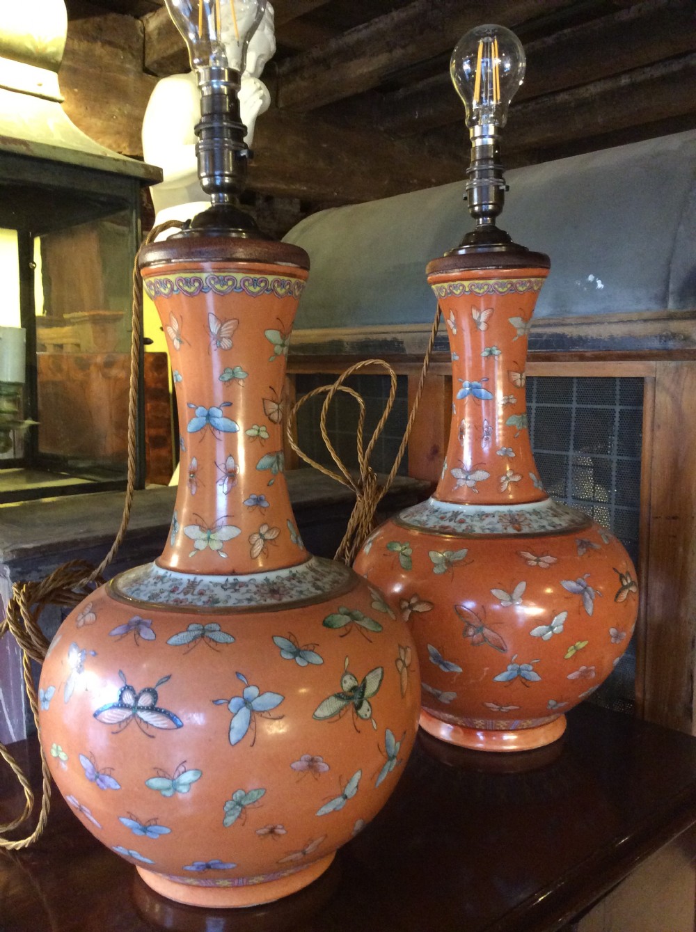 a very near pair of lamps both with thehundred butterfly pattern