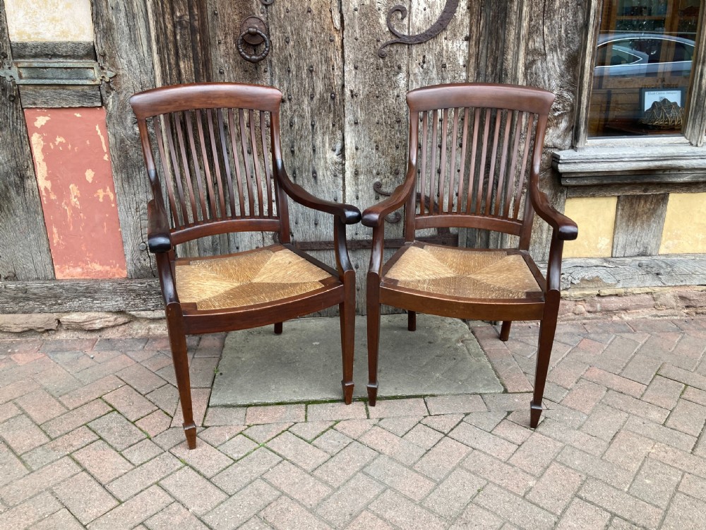 a pair of early 20th century mahogany rushseated armchairs c 1910